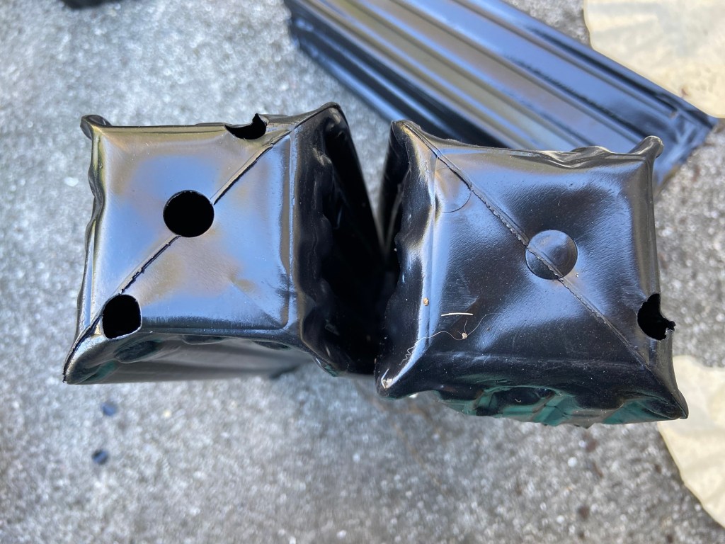 A photo showing how some pots have the draining holes cut out, and how some are missing the drainage holes